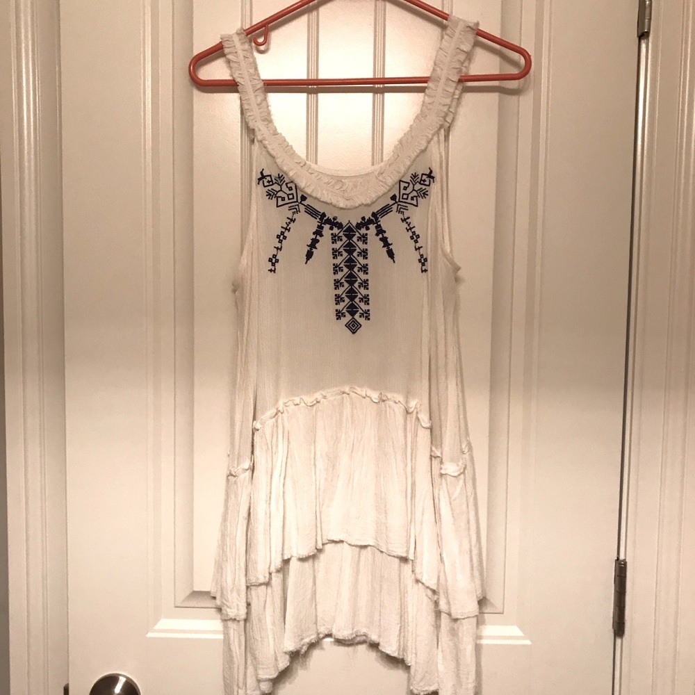 White beach tunic with stitched design.